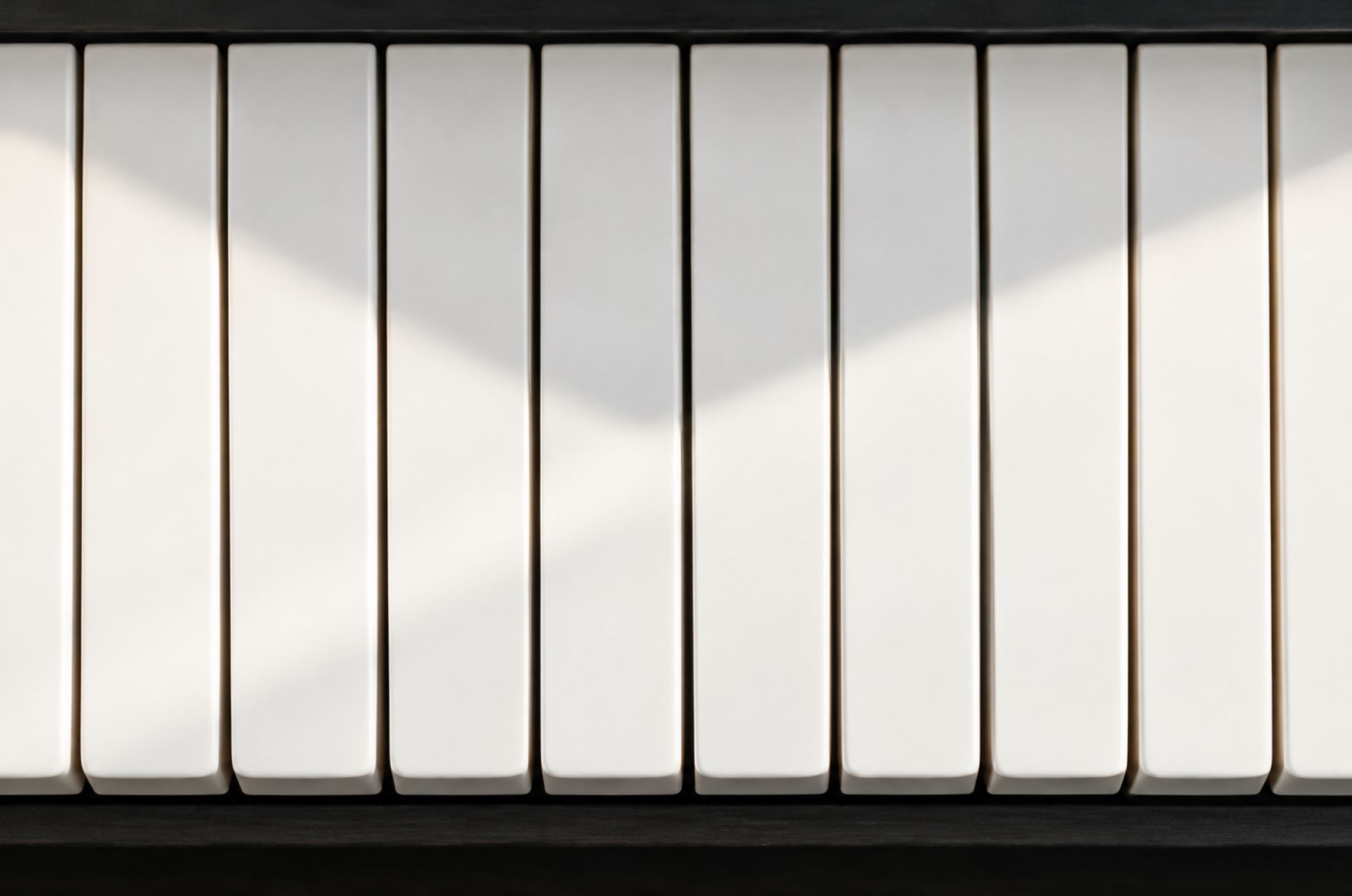 Overhead still life of a section of white piano keys photographed straight down, no black keys in frame, soft even daylight, a faint shadow falling diagonally across the keys, clean and minimal composition